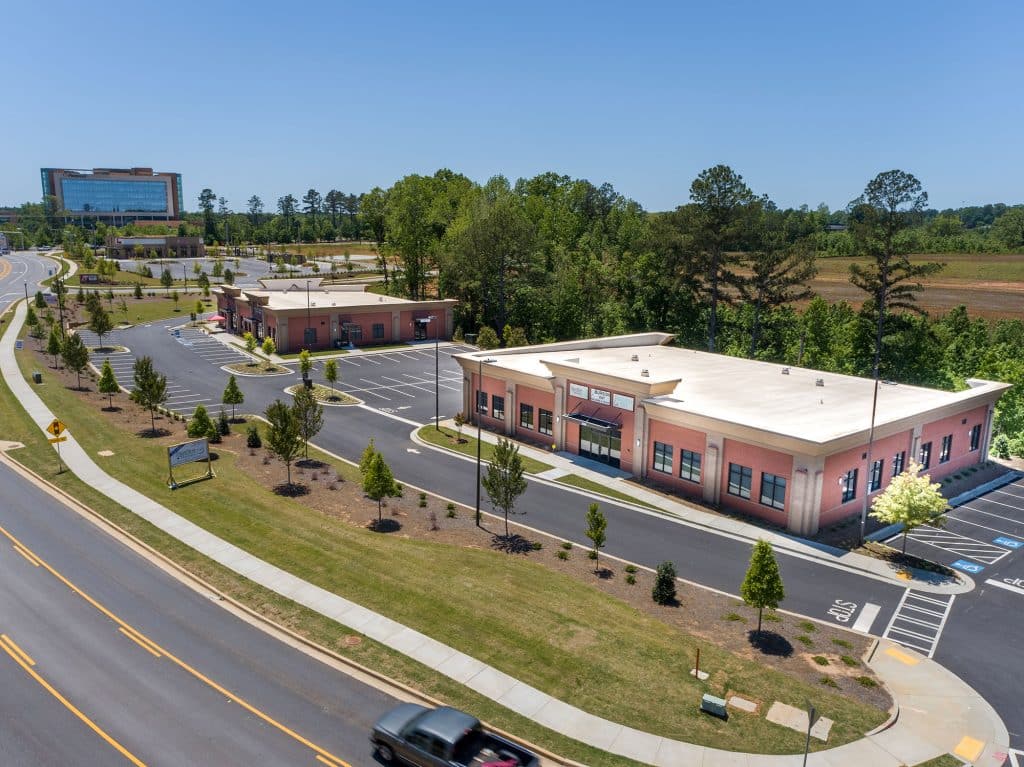 Aerial view of the two Newnan Crossing Blvd Professional Center brick buildings in Newnan, GA.