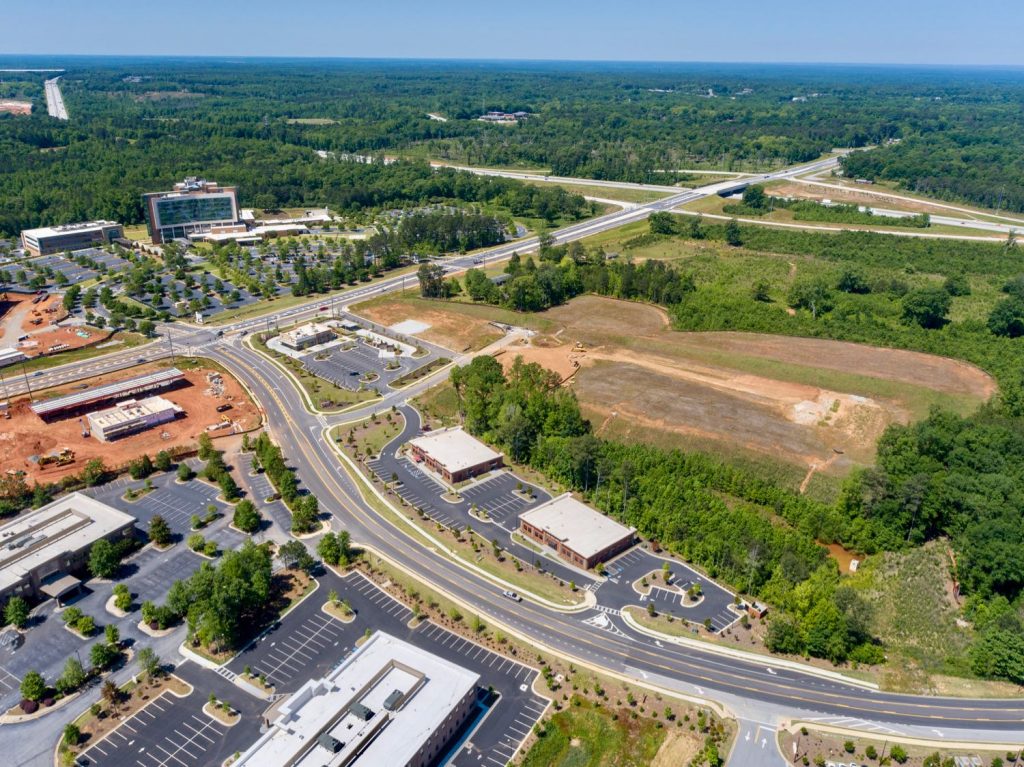 Aerial view of medical office buildings off of Newnan Crossing Blvd and view of I-85 interchange and Piedmont Newnan Hospital.