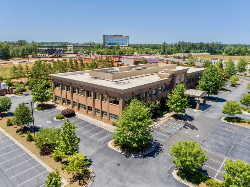 Aerial view of 2401 Newnan Crossing Blvd medical office building with Piedmont Newnan Hospital in the background.