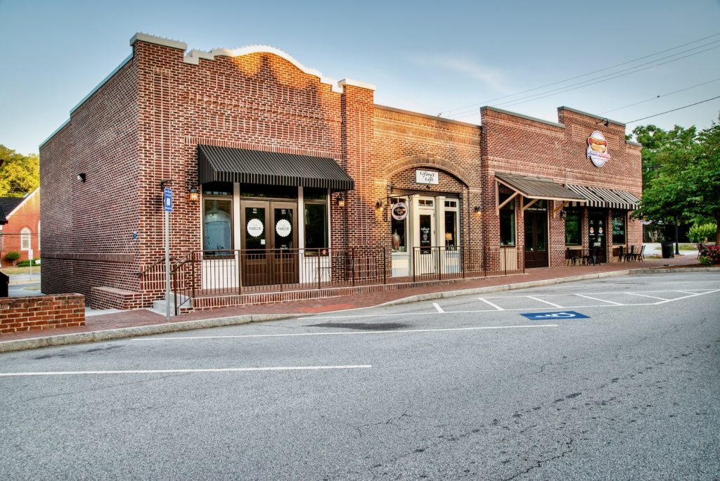 Front side view of brick retail building on Main Street in historic Senoia, GA.