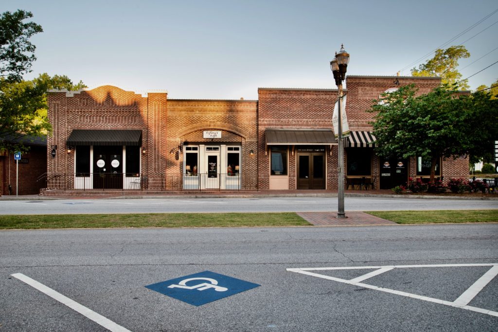 Front view of brick retail building on Main Street in historic Senoia, GA.