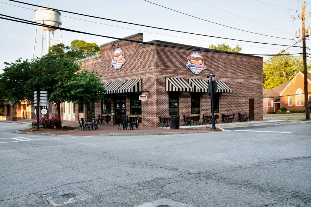 Side view of brick retail building on Main Street in historic Senoia, GA.