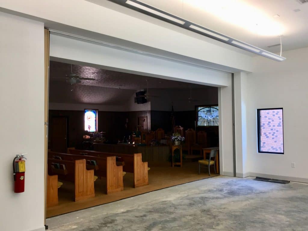 View of open partition between expansion room and sanctuary in the Flat Rock A.M.E. Church Expansion in Fayetteville, GA.